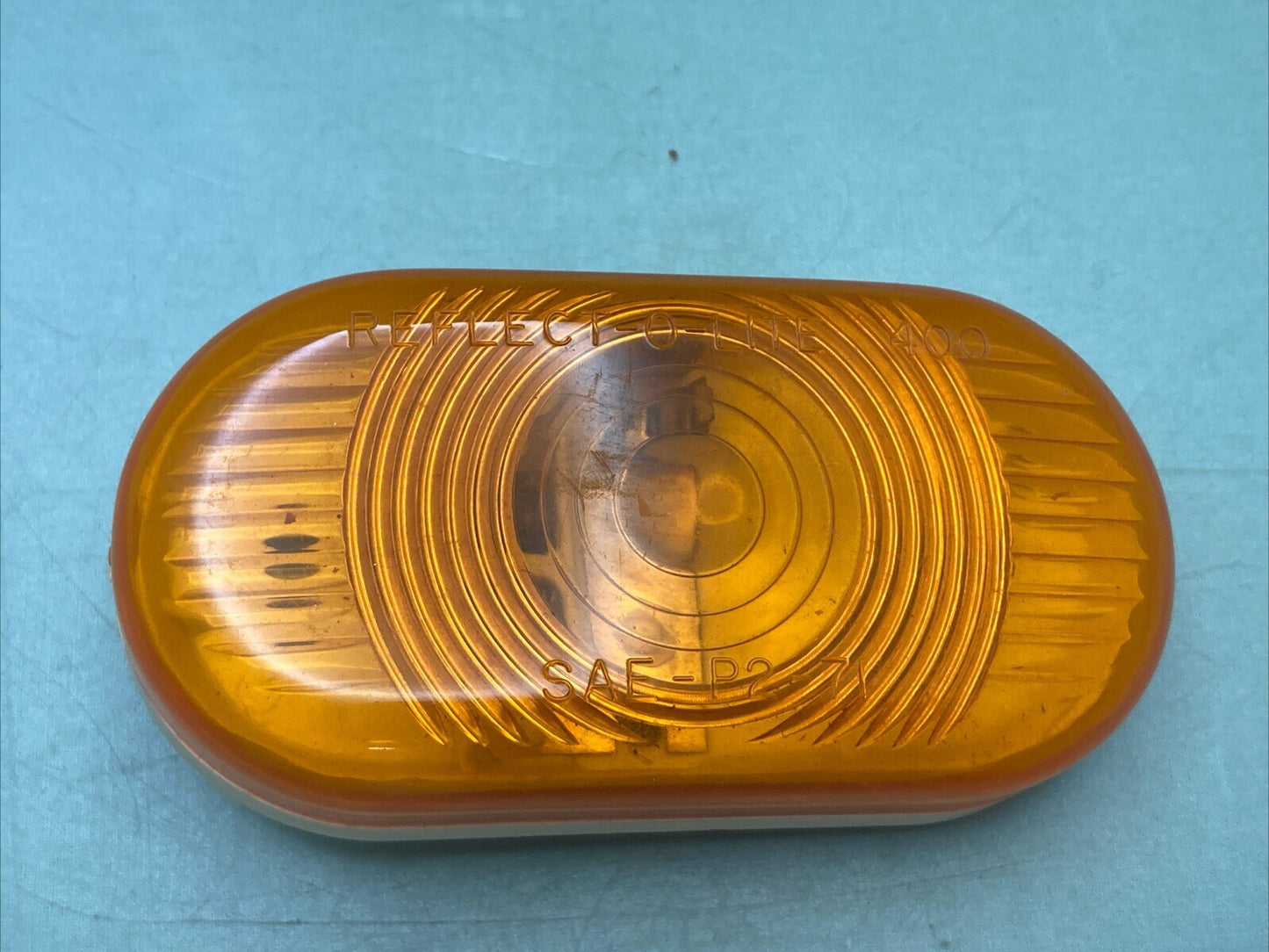 NEW REFLECT-O-LITE 400 SAE-P2-71 AMBER LENS CASING 73C103